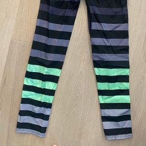 K-DEER capri length black, grey and green striped leggings.